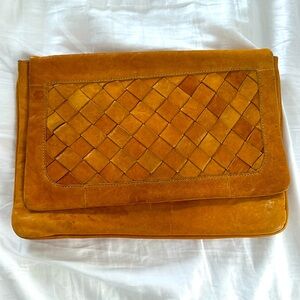 genuine leather clutch, magnetic closure, no strap. small stain, slight wear